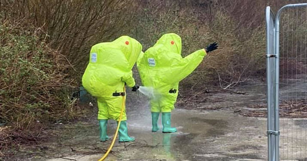 Hazmat-suited firefighters scramble to beach as mystery barrel of acid washes up