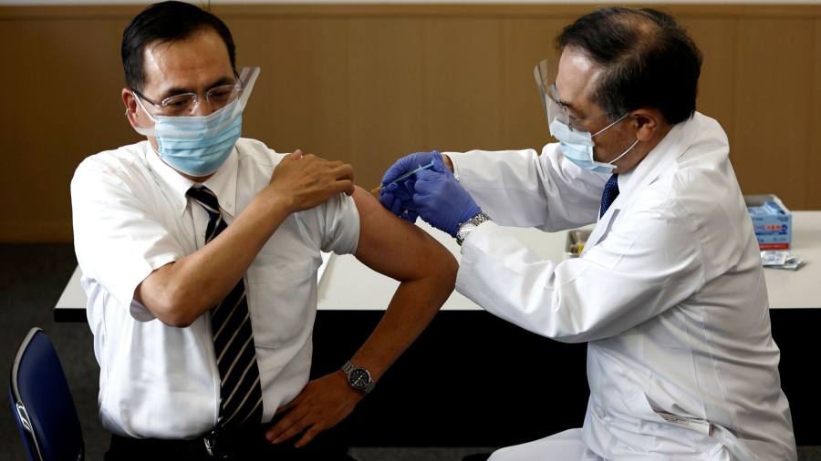 Japanese governor calls for Olympics to be cancelled as vaccination rollout begins