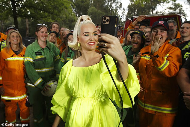 Pregnant Katy Perry meets firefighters before bushfire concert