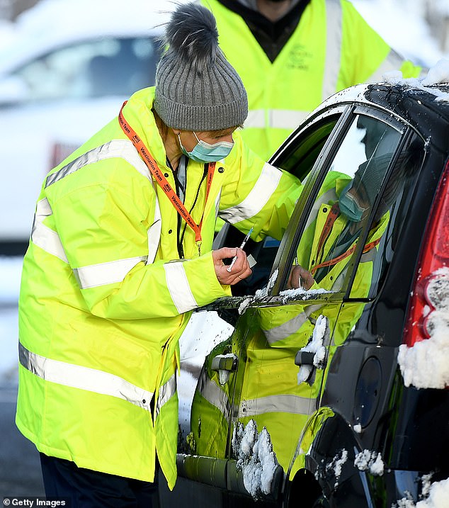 Motorists flock to drive-through vaccination centres to get the Covid-19 jab through car window