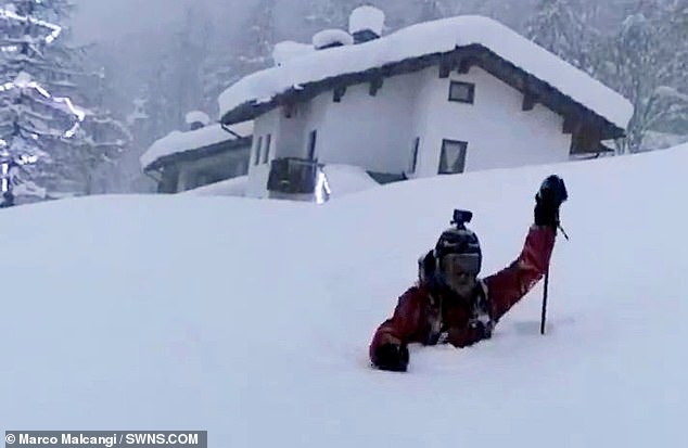 Think snow is deep near you? Italian has to wade through FIVE-FEET high snow to leave his houseÂ 