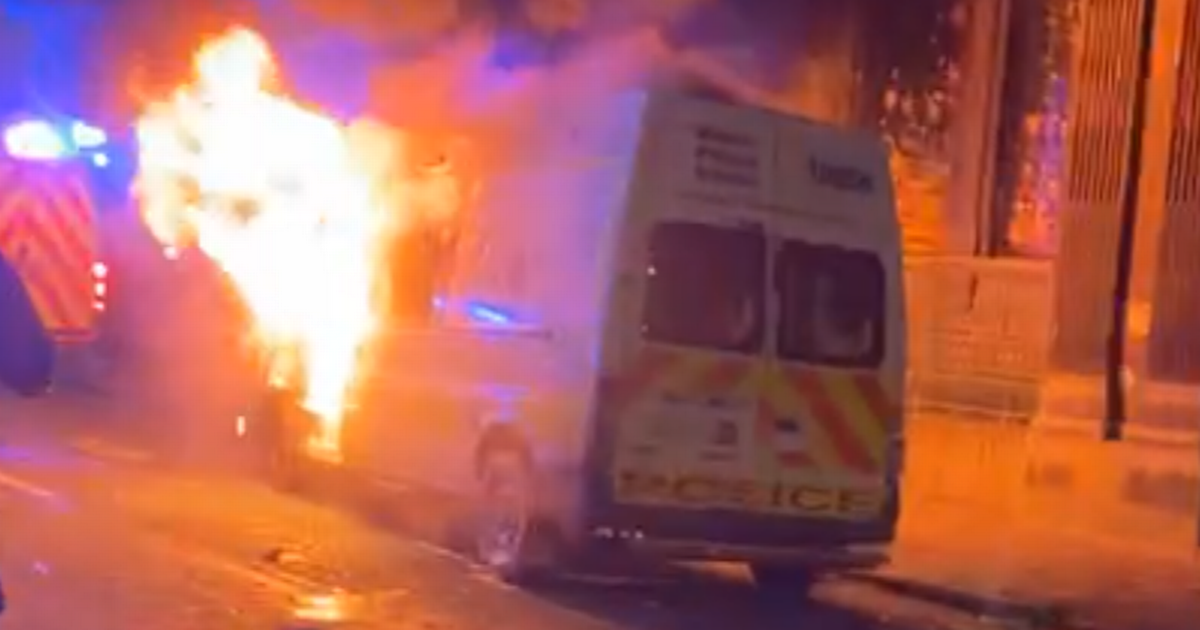 Bristol police station ‘under siege’ as rioters set fire to van and ‘climb roof’